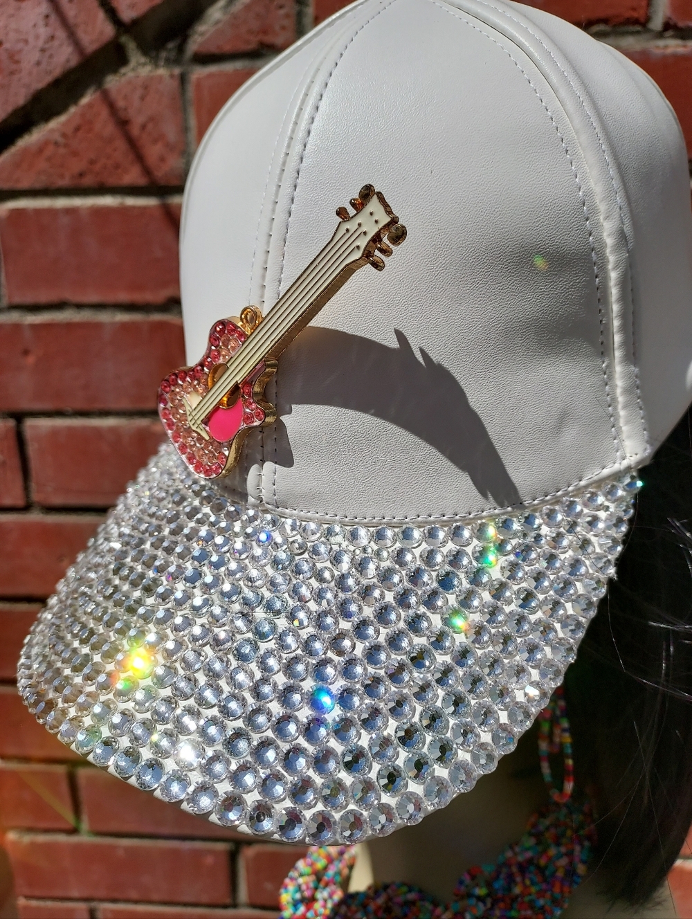 Swarovski Crystal White Baseball Cap with Pink crystals on the Guitar